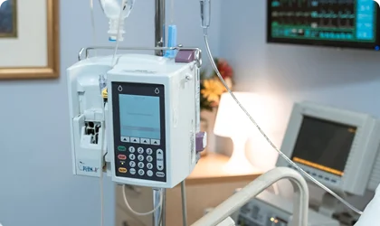 Hospital IV infusion pump with digital display in medical setting