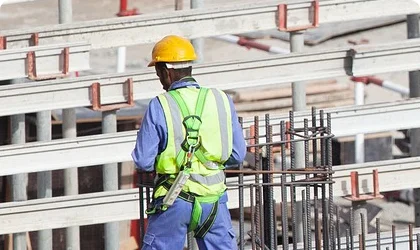 Construction worker wearing a safety harness for lone worker monitoring.