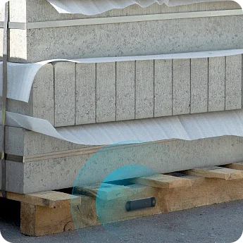 M11 pallet tracking tag embedded in a wooden pallet carrying concrete slabs
