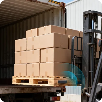 M11 Bluetooth pallet tracker on a loaded pallet being moved into a shipping container by a forklift