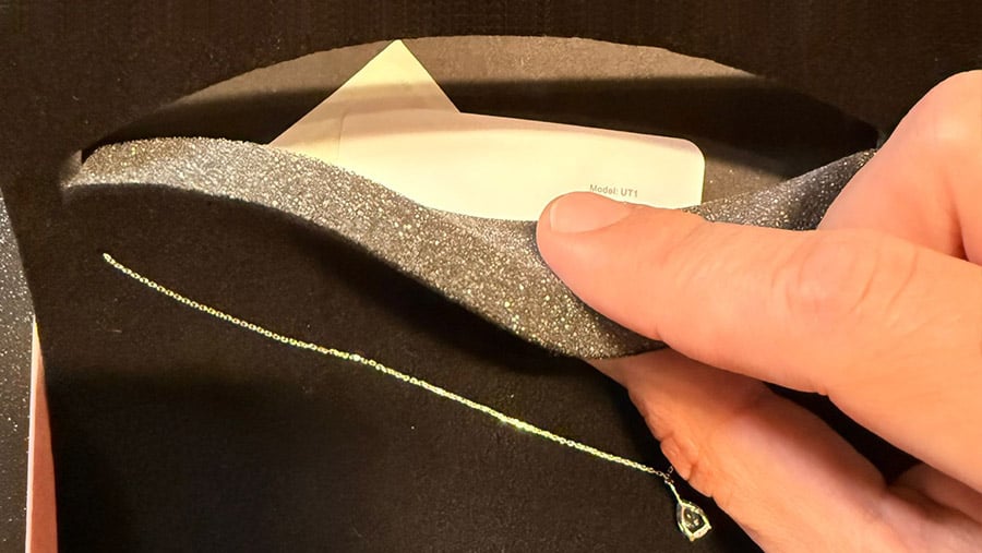 UT1 BLE tag model tucked inside a jewelry box lining for discreet inventory management