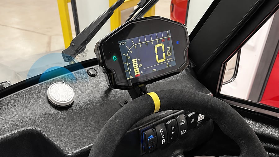 H2 BLE wayfinding beacon mounted on low-speed vehicle dashboard emitting Bluetooth signal.