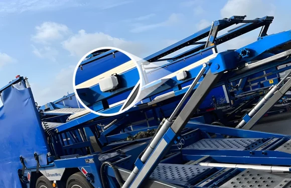 lw001 lorawan gps tracker installed on blue car carrier truck for real-time vehicle monitoring